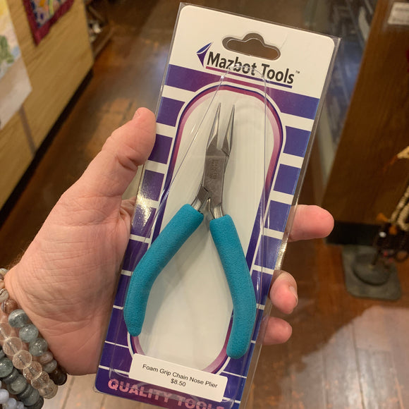 A womans hand holding a flat nose flatnose jewelry plier