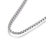 zoomed in portion of stainless steel Venetian box chain on white background. 