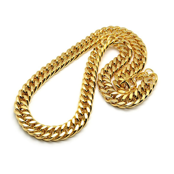 golden large Cuban link chain necklace with lobster claw clasp on white background. 