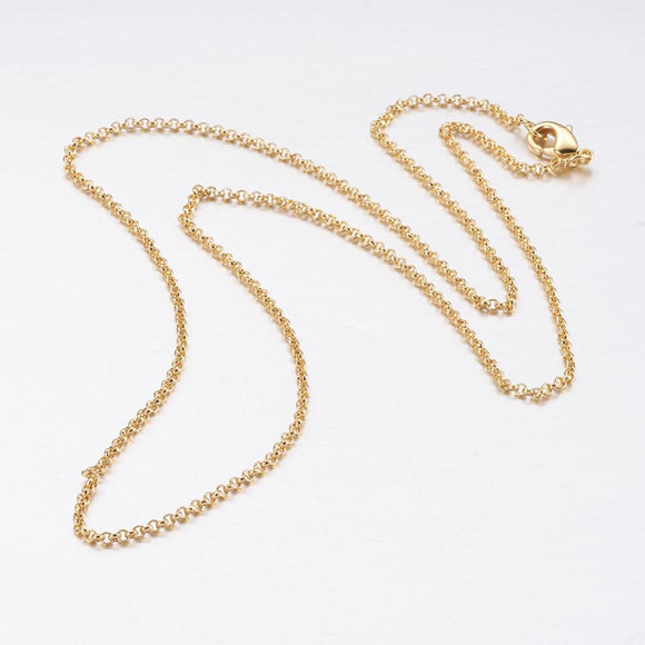 golden rolo chain necklace with lobster claw clasp on white background. 