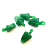 vintage green glass bell pepper charms on a white background