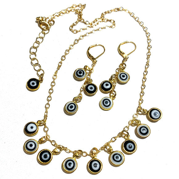 This is a gold chain necklace with small glass evil eye charms dangling from it. There is a photo of matching earrings, chain with three drops per ear. 
