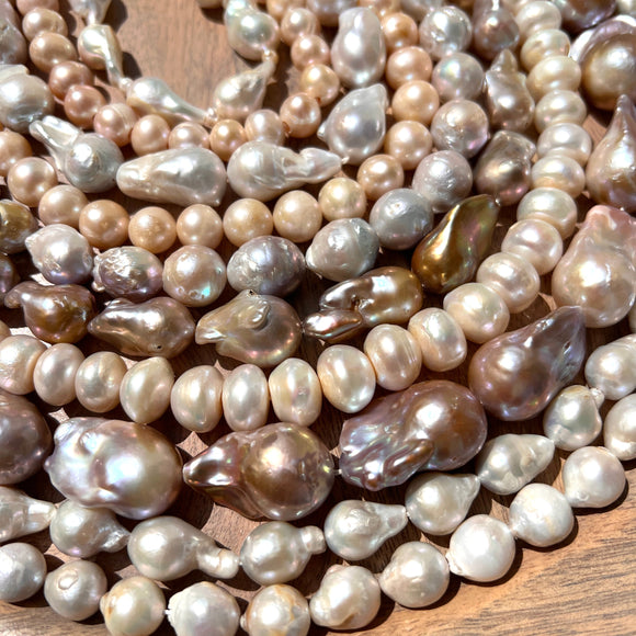 This is a beautiful photo of rows of beautiful freshwater pearls in a variety of shapes. Baroque pearls,  teardrop, round, rondelle, edison pearls and more. We have a huge pearl selection. 