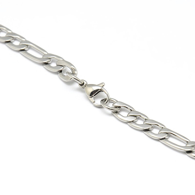 zoomed in section of the lobster claw clasp to a silver tone Figaro chain necklace on a white background. 