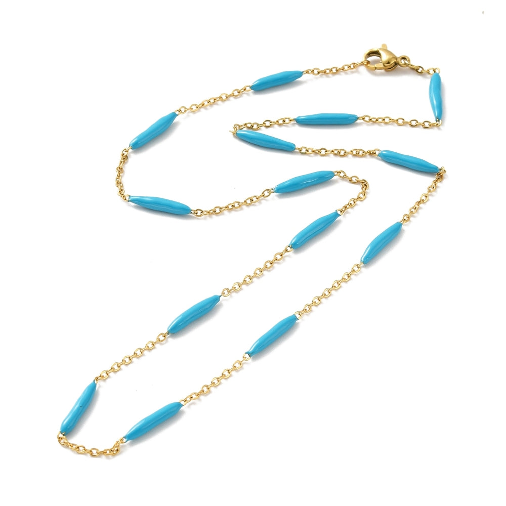 golden curb chain and blue enamel bar link necklace with lobster claw clasp on white background. 