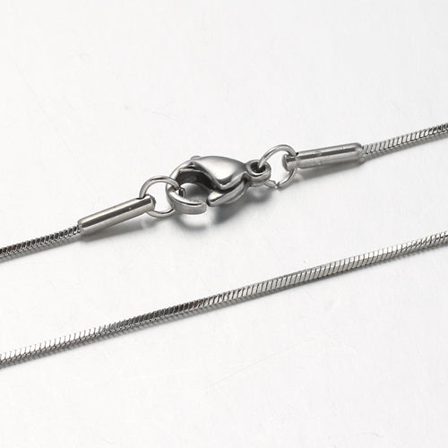 zoomed in sections of silver tone square snake chain necklace with lobster claw clasp on white background. 