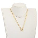 golden paperclip chain necklace with large spring ring clasp on off white neck form on  white background. 