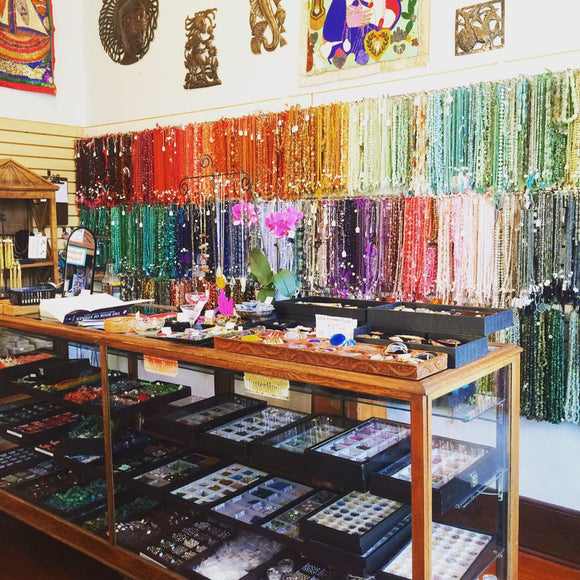 The best bead shop welcomes you with their beautiful stone room. This image shows our vintage wood case full of natural gemstones organized in neat jewelry trays. 