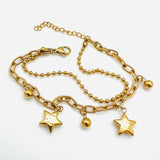 golden double layered, paperclip and ball chain bracelet with lobster claw clasp and extender on white background.  the paperclip chain dangles alternating ball and star charms. 