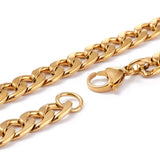 zoomed in portion of golden curb link chain necklace with lobster claw clasp on a white background. 