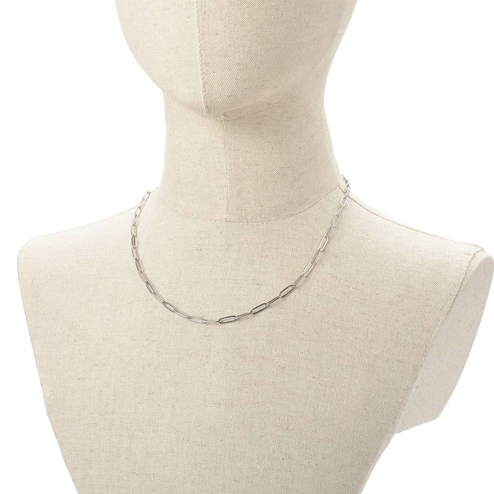 silver tone medium link paperclip chain necklace on burlap neck form with white background. 