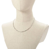 stainless steel medium link paperclip chain necklace on burlap neck form with white background. 