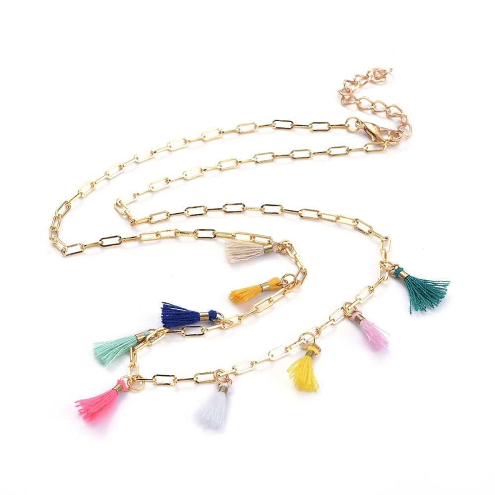 golden paperclip necklace with nine multi-colored tassel charms spaced evenly through the center and a lobster claw clasp and extender chain on white background. 