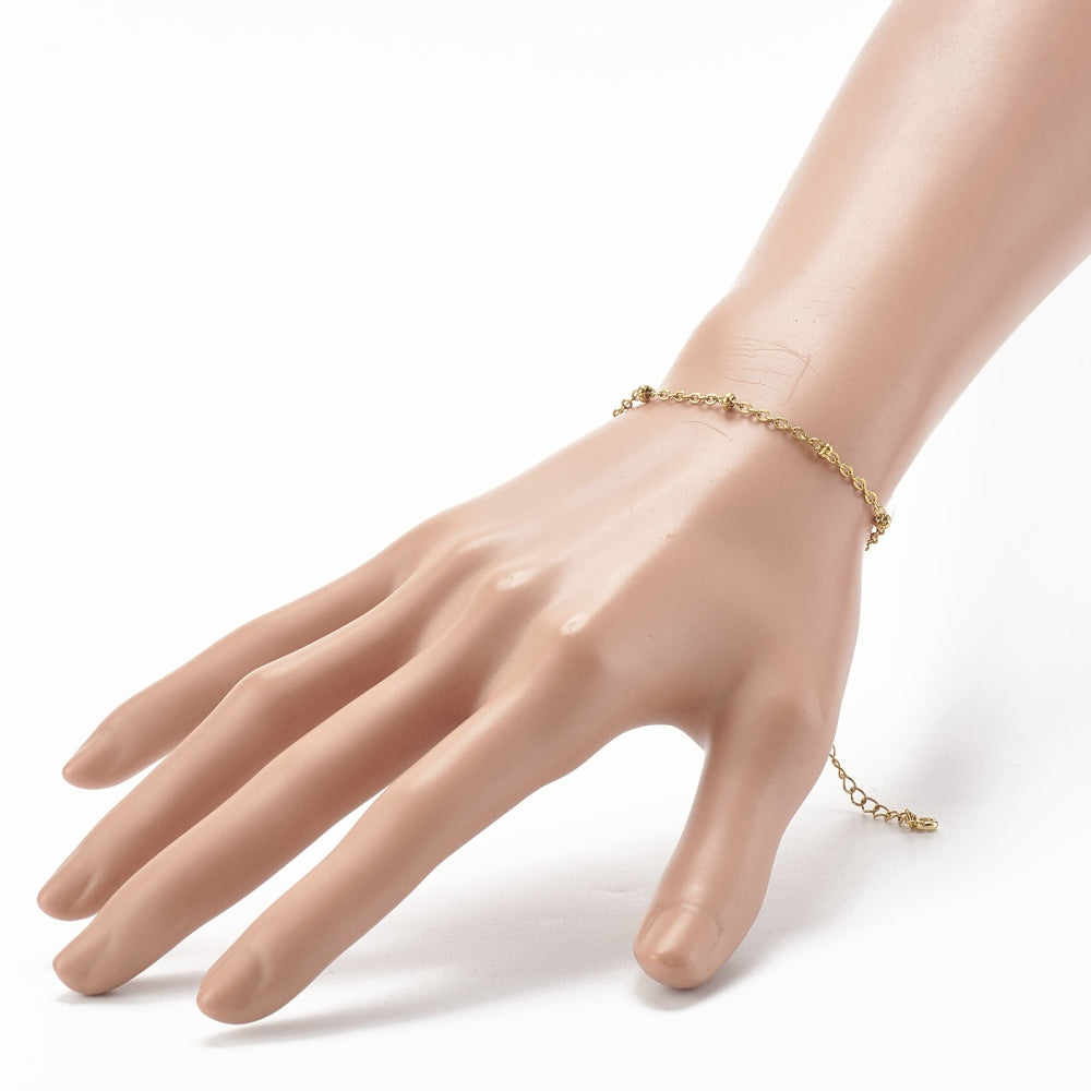 golden satellite chain bracelet with extender on a mannequin arm with white background. 