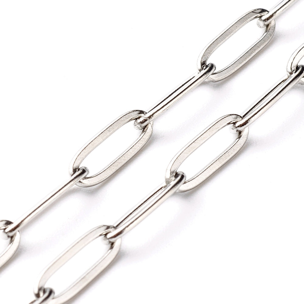 zoomed in sections of silver tone medium link paperclip chain necklace on white background. 