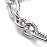 zoomed in section of stainless steel heavy Figaro chain bracelet on white background. 