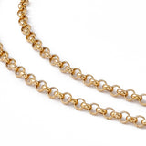 zoomed in section of golden medium Rolo chain necklace on white background. 