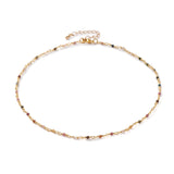 golden chain and multi-colored tourmaline faceted round beaded necklace with golden lobster claw clasp and extender chain over white background. 