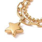 zoomed in section of golden star charm on paperclip and ball chain bracelet on white background. 