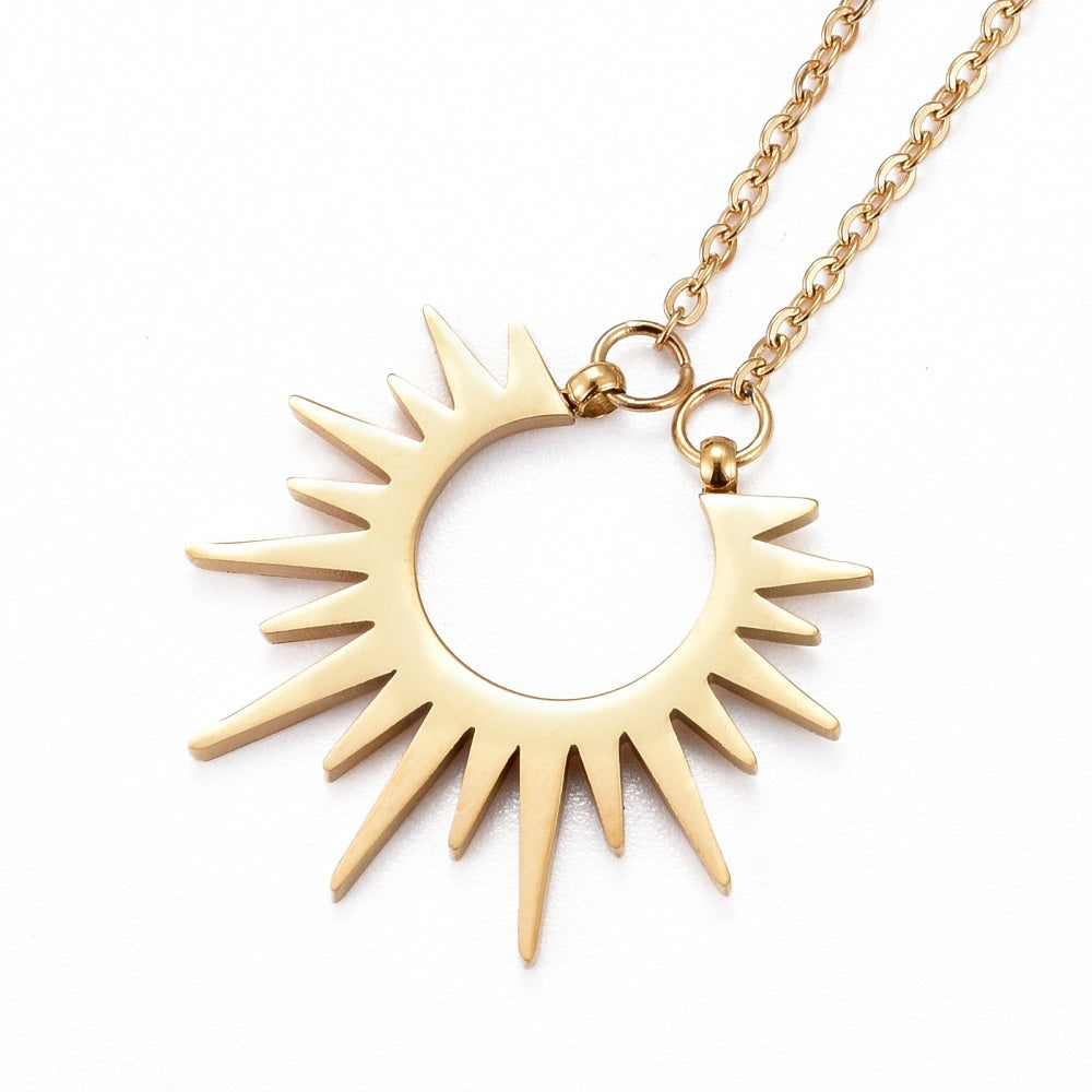 golden sun pendant necklace on cable chain on white background. 