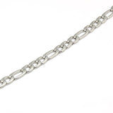 zoomed in section of stainless steel Figaro chain necklace a white background. 