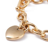 zoomed in golden heart charm on golden charm bracelet on a white background. 