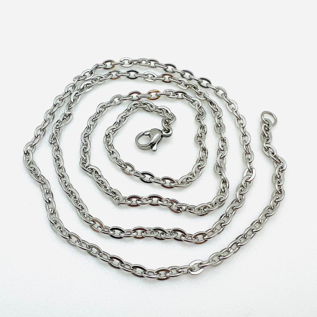 silver tone flat cable chain necklace with lobster claw clasp in a swirl design over white background. 