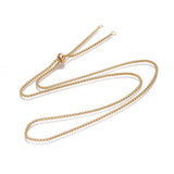 golden Venetian box chain Bolo necklace with slider bead and 2 jump rings on white background. 