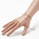 golden paperclip chain bracelet with lobster claw clasp and extender chain displayed alone on a mannequin wrist with a white bacground.