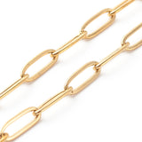 zoomed in sections of golden medium link paperclip chain on white background. 