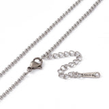 zoomed in sections of stainless steel Rolo chain with lobster claw clasp and extender chain on white background. 