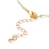 zoomed in section of golden chain and turquoise amazonite faceted round beaded necklace with golden lobster claw clasp and extender chain over white background. 
