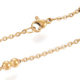 zoomed in section of golden cable link double satellite chain necklace with lobster claw clasp on a white background. 