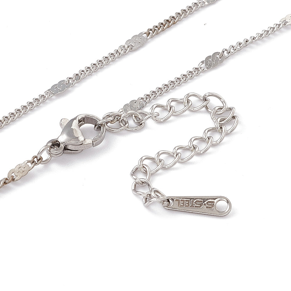 zoomed in sections of stainless steel flat satellite curb chain with lobster claw clasp  and extender on  white background. 
