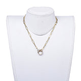 golden paperclip chain necklace with focal clear stone pave lobster claw clasp displayed on white neck form with white background. 