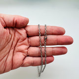 silver tone flat cable chain necklace with lobster claw clasp draped over a hand over white background. 