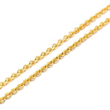 zoomed in section of golden flat cable chain on a white background. 
