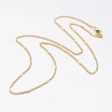 golden flattened link curb chain necklace with lobster claw clasp on a white background. 