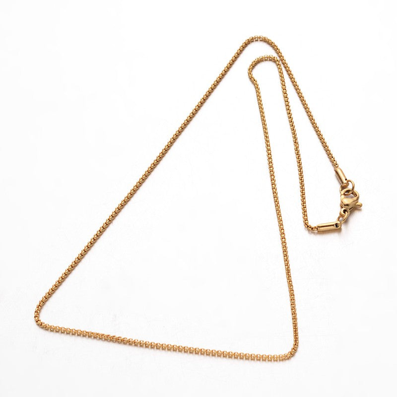 golden box chain necklace with lobster claw clasp over white background. 