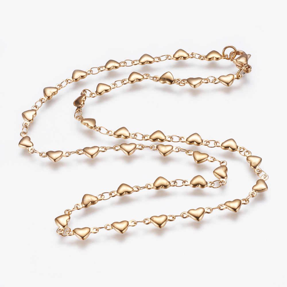 golden flat heart link necklace with lobster claw clasp on white background. 