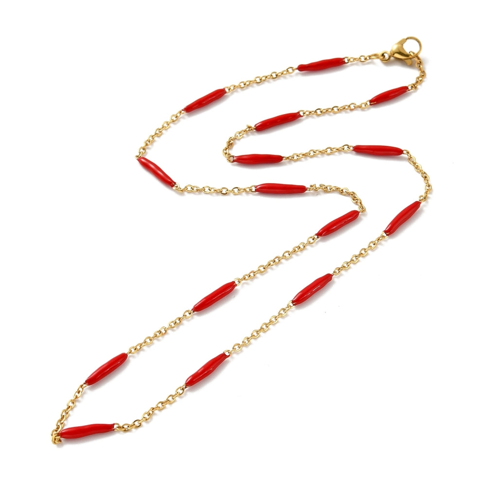 golden curb chain and red enamel bar link necklace with lobster claw clasp on white background. 