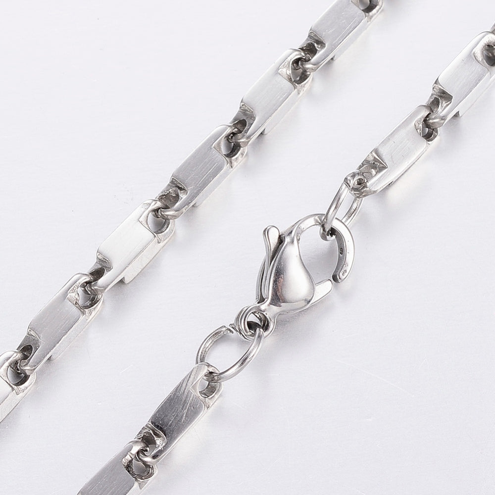 zoomed in sections of stainless steel vintage inspired link necklace with lobster claw clasp on white background. 