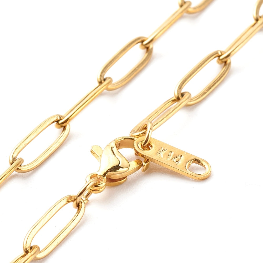 zoomed in sections of golden medium link paperclip chain necklace with lobster claw clasp on white background. 