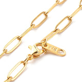 zoomed in sections of golden medium link paperclip chain necklace with lobster claw clasp on white background. 