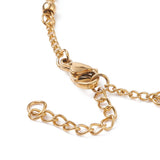 zoomed in section of golden lobster clasp and extender chain on a white background. 
