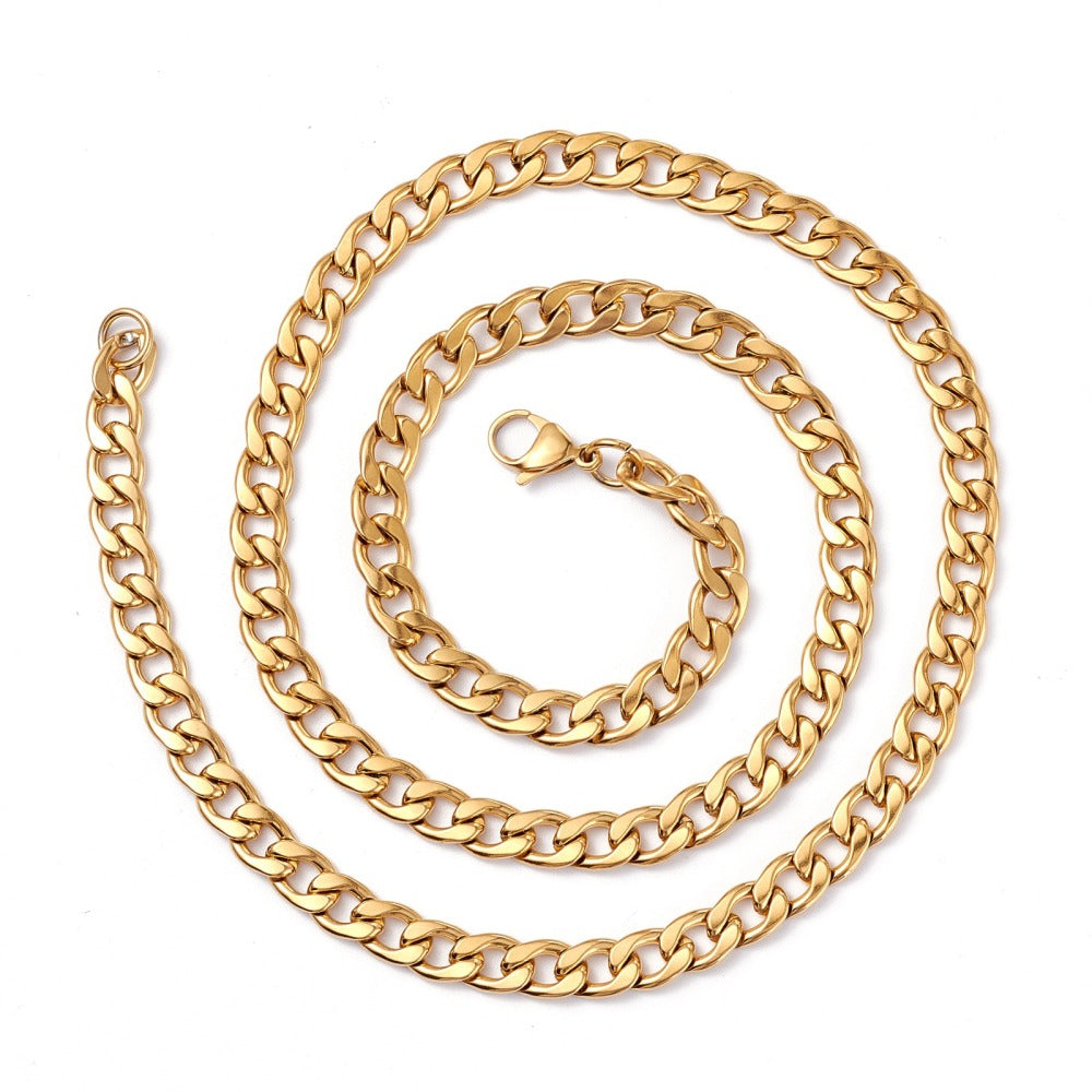 golden curb link chain necklace with lobster claw clasp on a white background. 