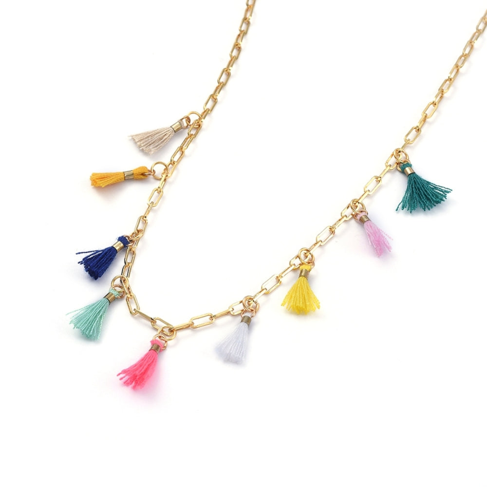 golden paperclip necklace with nine multi-colored tassel charms spaced evenly through the center on white background. 