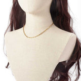 golden paperclip chain necklace on a brunette mannequin neck on white background. 