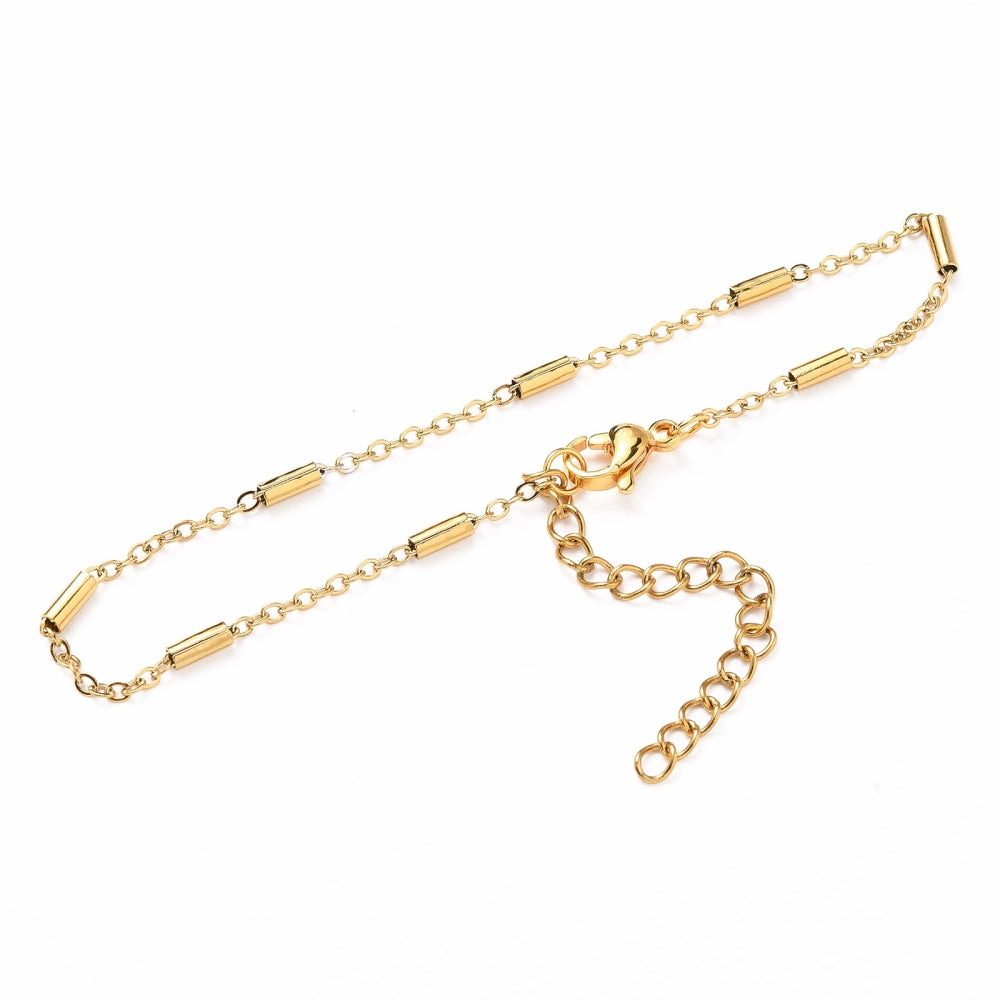 golden satellite tube chain bracelet with lobster claw clasp and extender on white background. 