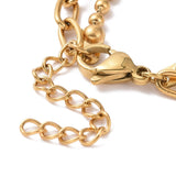 zoomed in golden lobster claw clasp and extender on paperclip and ball chain with white background. 